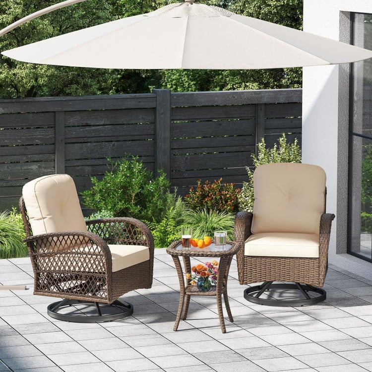 Patio swivel rocker set with thick cushions and tempered glass side table, perfect for backyard relaxation.
