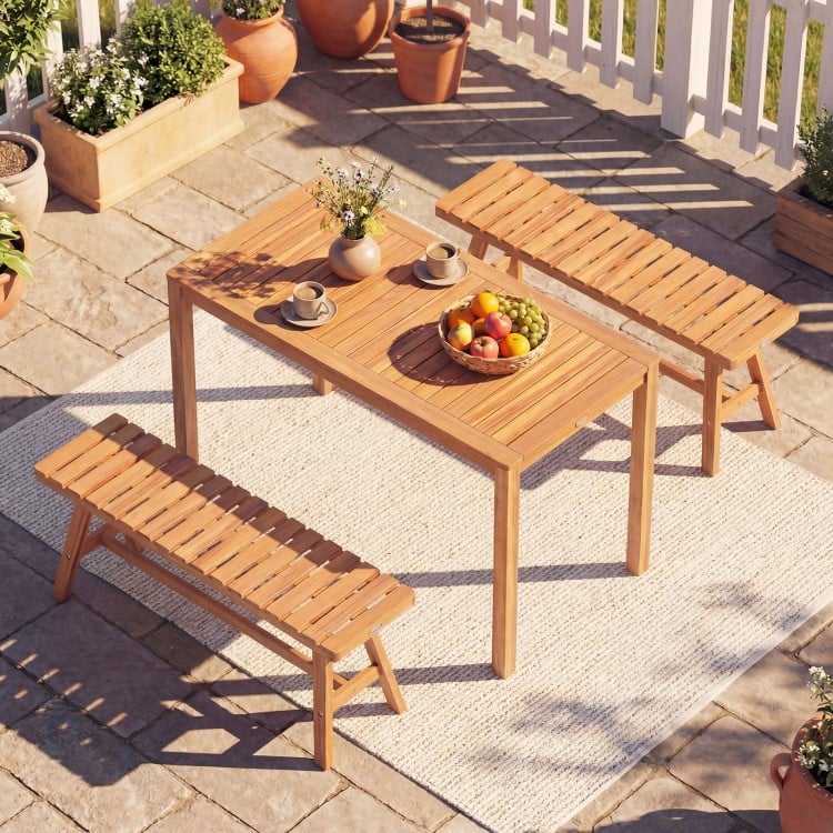 Acacia wood patio dining set featuring a rectangular table and two slatted benches, perfect for outdoor gatherings.