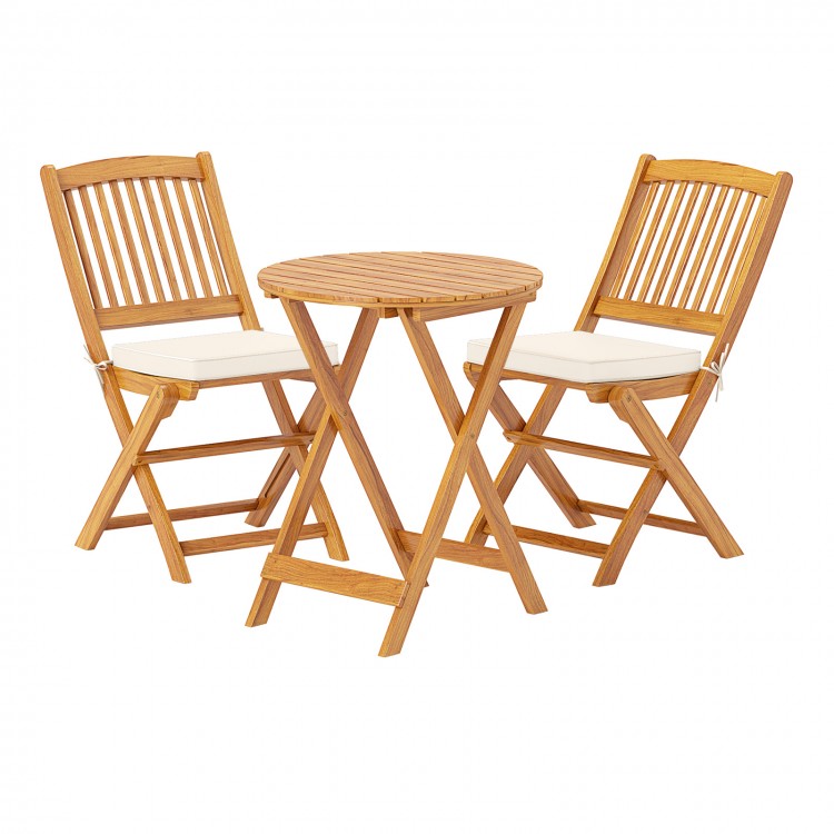 Acacia wood patio bistro set with two folding chairs and soft beige cushions, perfect for outdoor dining or lounging.