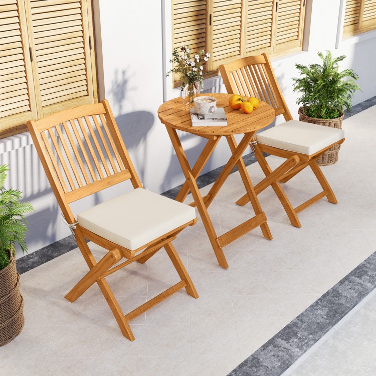 Acacia wood patio bistro set with beige cushions, featuring a folding design for easy storage, ideal for outdoor dining.