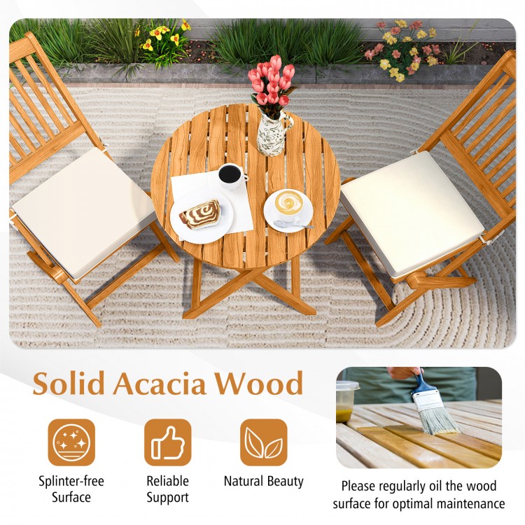 Acacia wood patio bistro set with beige cushions, featuring a splinter-free surface and folding design for easy storage.