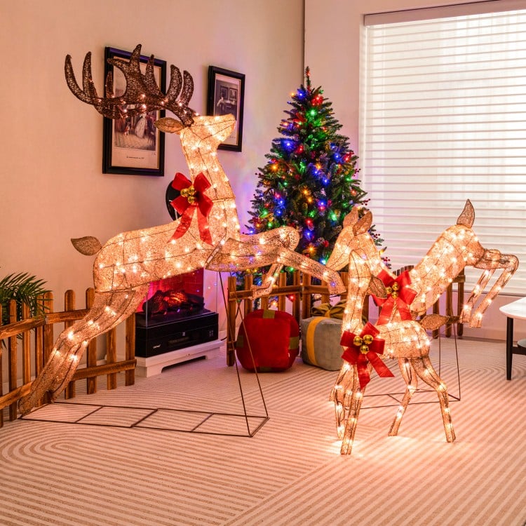 Lighted Christmas reindeer family set with 255 lights, featuring golden finish and festive red bows, perfect for indoor.