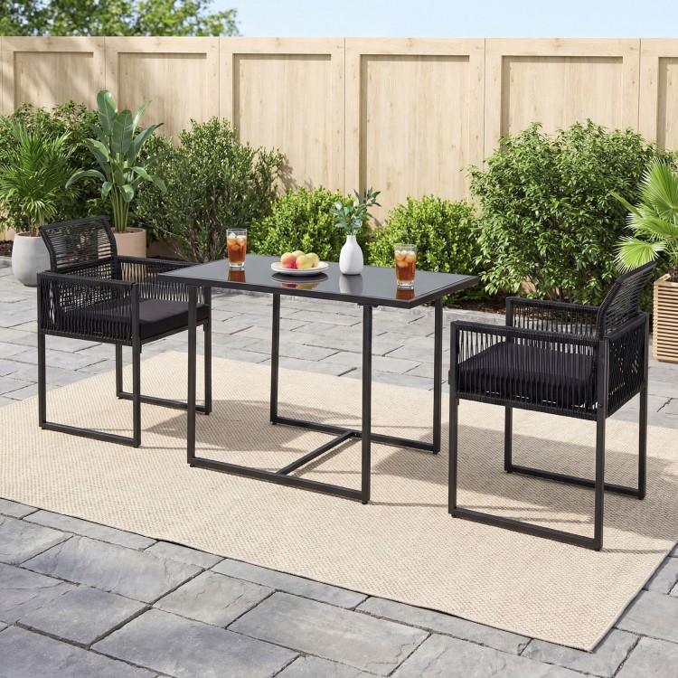 Outdoor dining set featuring a black folding backrest, soft cushions, and a spacious tempered glass table for backyard.