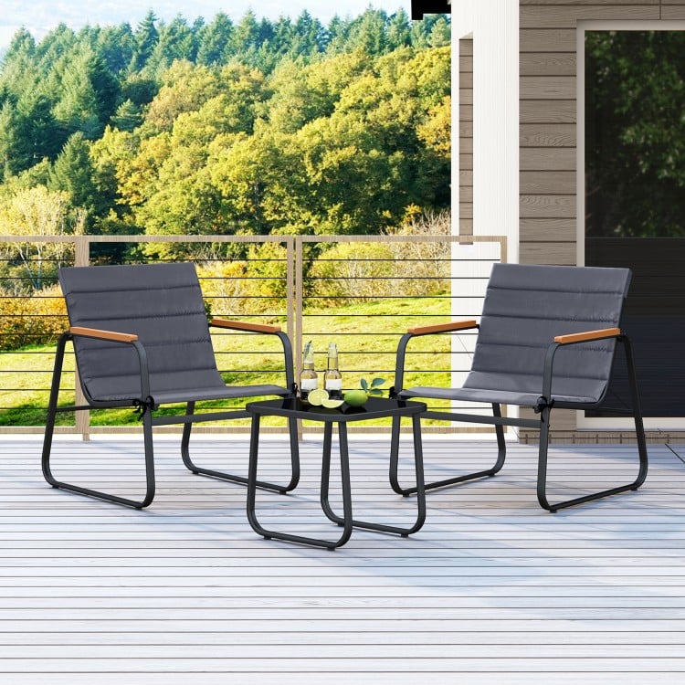 Two gray outdoor chairs with removable cushions and a square side table, perfect for patio conversation.