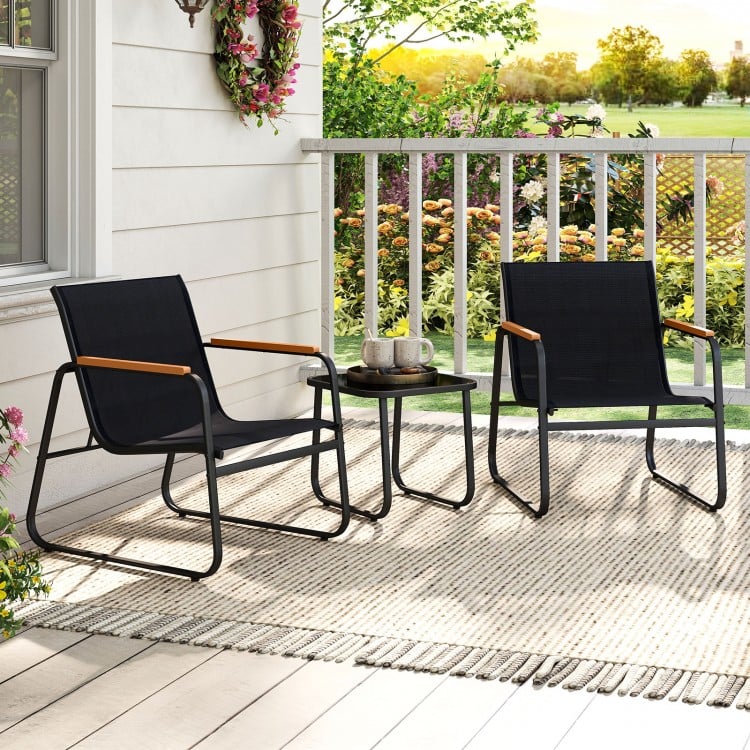 Two gray patio chairs with wood-plastic armrests and a square side table, perfect for outdoor relaxation on a balcony.