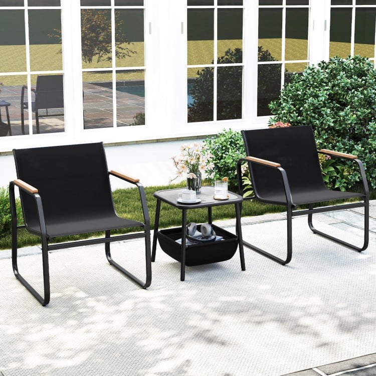 Cozy outdoor bistro set featuring two black chairs with wood armrests and a stylish square table for relaxing patio.
