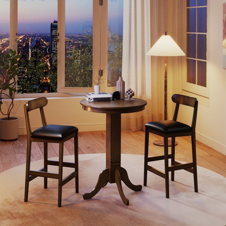 Round wood bar table set with pedestal base and two armless stools, ideal for intimate meals in a cozy setting.