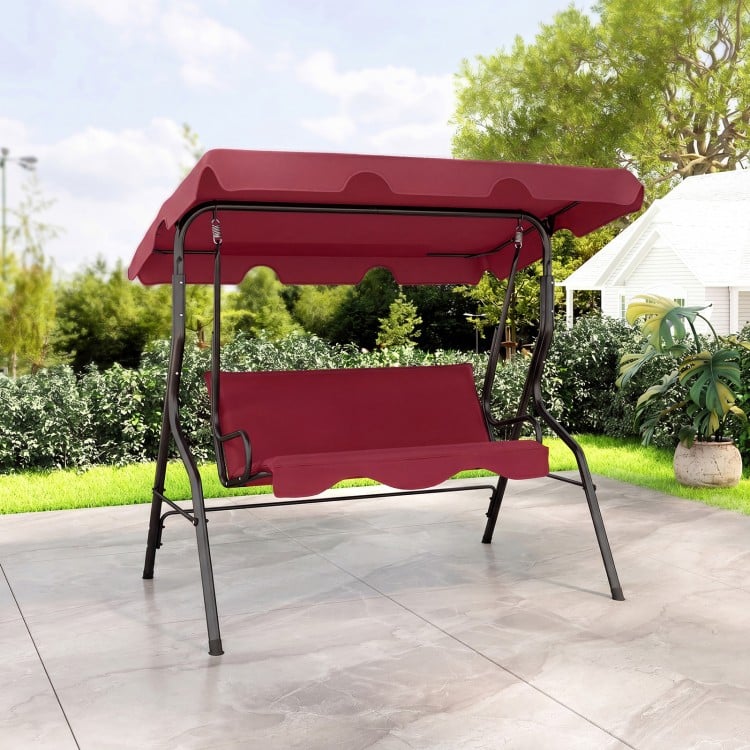 Three-seat outdoor patio canopy swing with cushioned steel frame in red, perfect for relaxing in your garden.