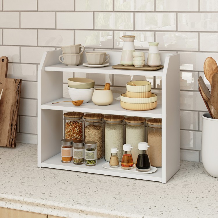 Three-tier white wooden countertop bookshelf with raised guardrails, ideal for organizing books and kitchen items.