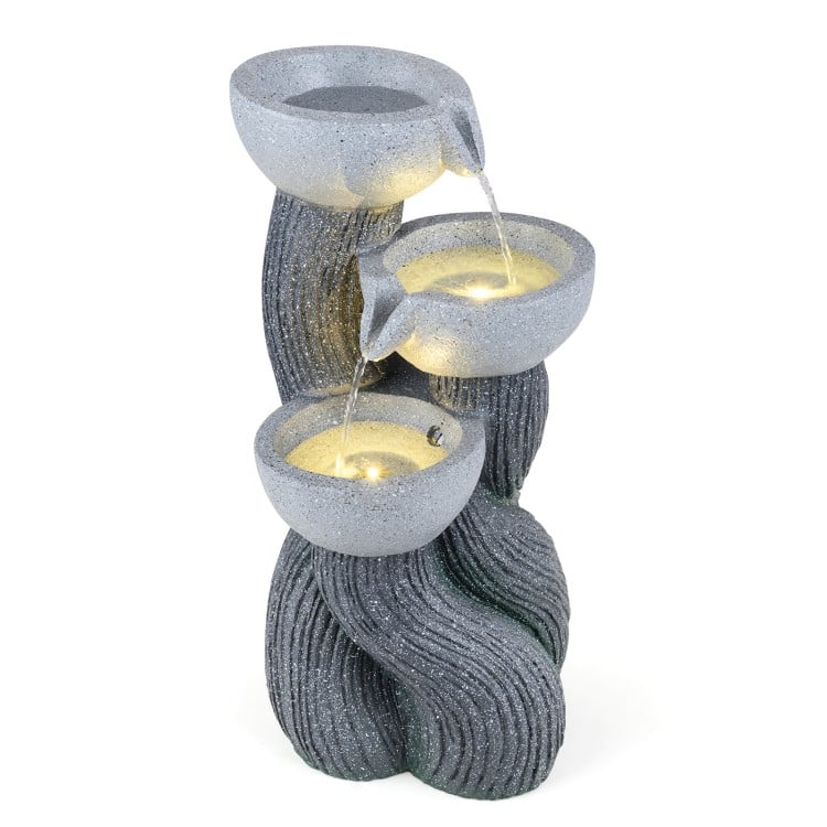 Three-tier outdoor water fountain with LED lights, resin construction, and cascading design for patio relaxation.