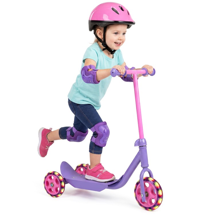 Child riding a purple 3-wheel scooter with LED light-up wheels, featuring a wide anti-slip deck for stability.