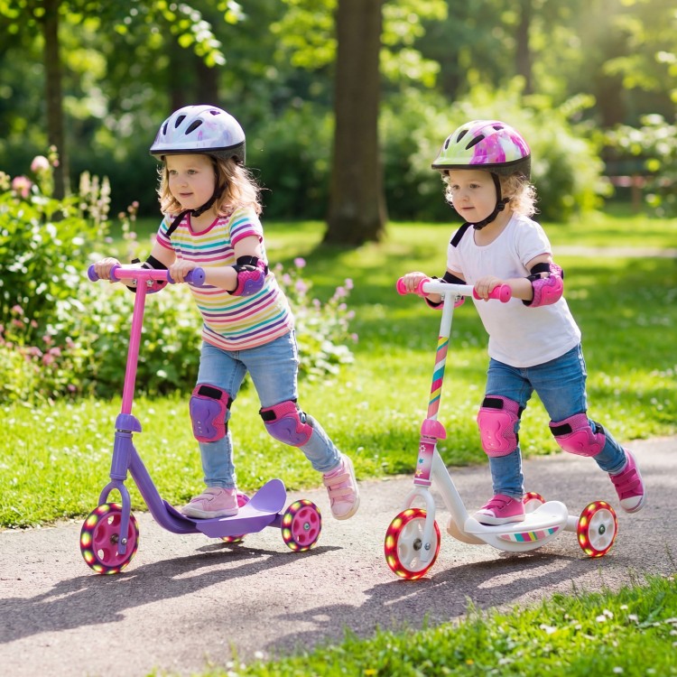 Two kids riding 3-wheel scooters with LED light-up wheels in a park, promoting balance and coordination.