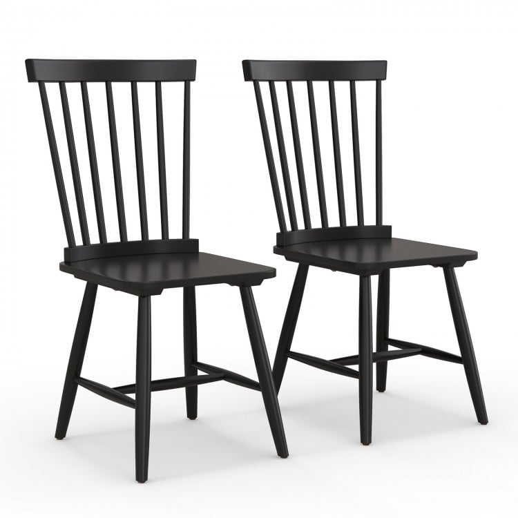 Two black Windsor chairs with high spindle backs and wide seats, designed for comfort and style in dining settings.