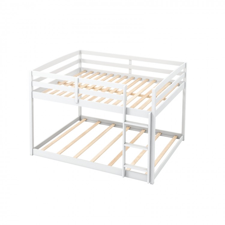 Low-to-ground white full over full bunk bed with solid wood frame and integrated ladder for easy access.