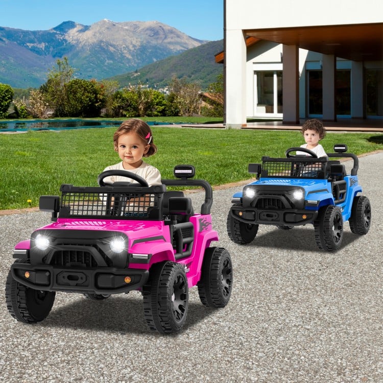 Two kids driving battery-powered electric trucks in pink and blue, featuring LED headlights and safety seat belts.