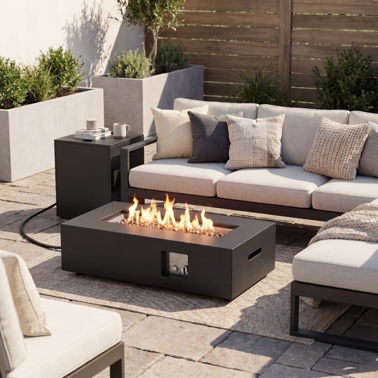 Rectangular 42-inch outdoor fire table with 50,000 BTU output, removable lid, and tank holder for patio warmth.