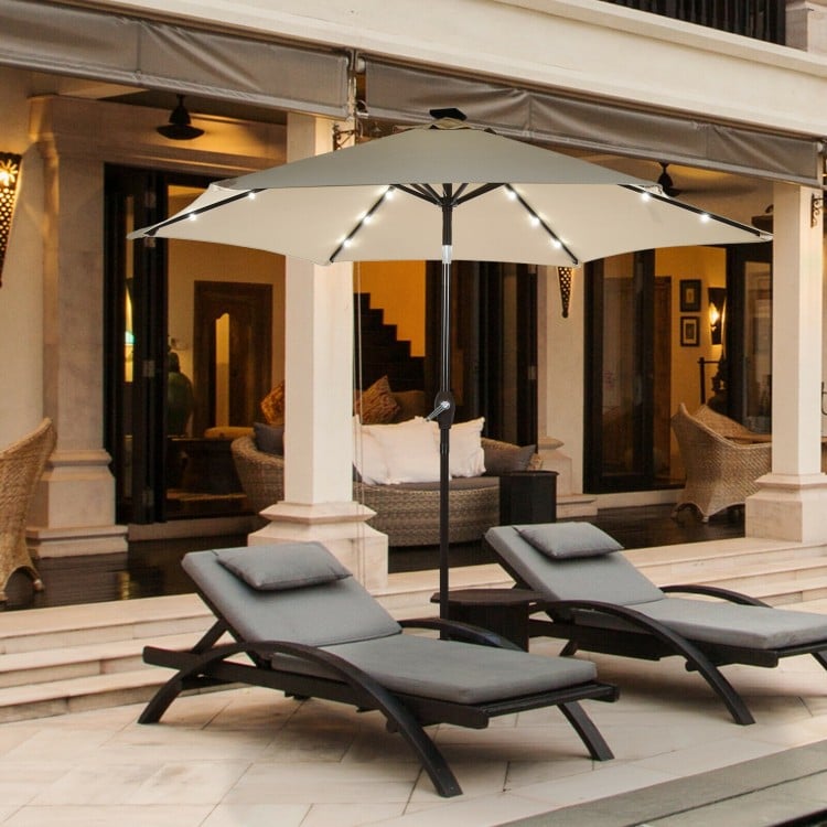 Beige 9' solar LED lighted patio umbrella with tilt adjustment, featuring a sturdy iron pole and elegant design for.