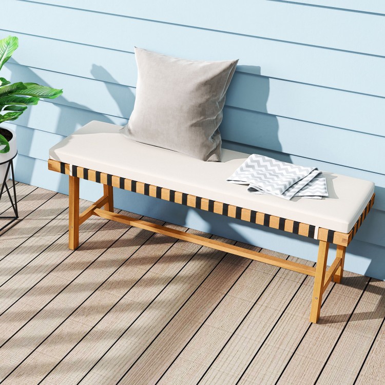 Acacia wood outdoor bench with thick padded seat cushion, ideal for garden or entryway seating, featuring a smooth.