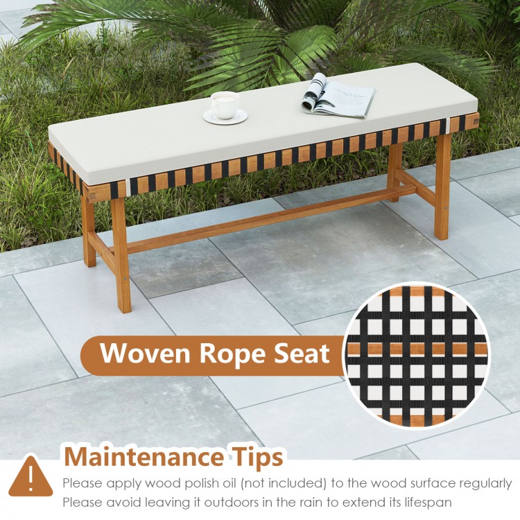 Acacia wood outdoor bench with thick padded seat cushion, featuring a woven rope design for comfort and ventilation.