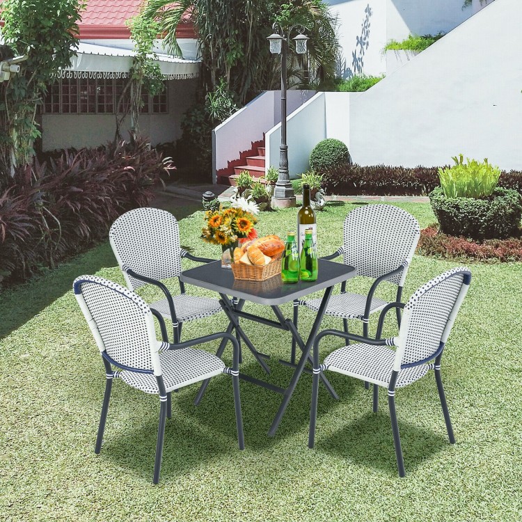 Set of 4 stackable patio dining chairs in white rattan, perfect for outdoor use in garden or backyard settings.