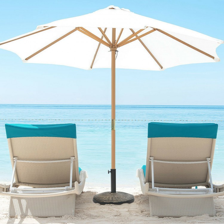 Patio market umbrella base stand with rattan design, durable resin, and anti-rust steel for stability by the poolside.