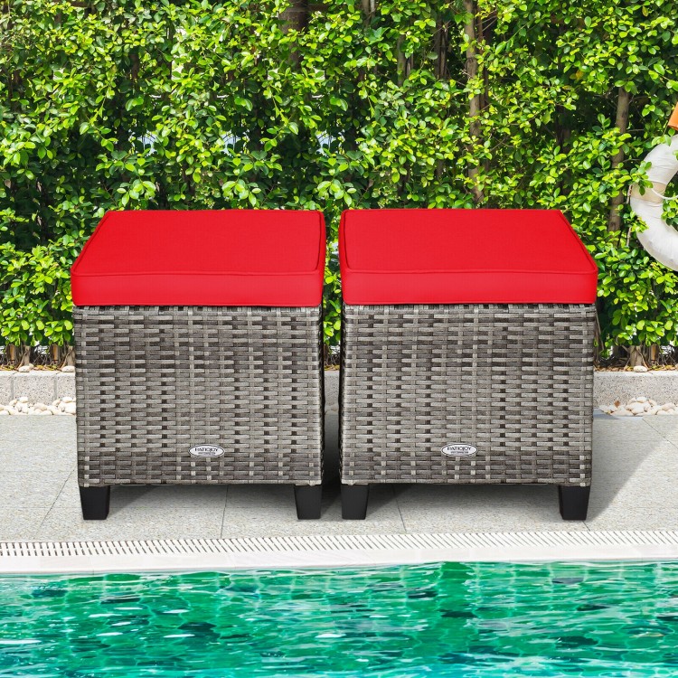 Two outdoor rattan ottomans with red removable cushions, perfect for patio or poolside use, featuring durable PE rattan.