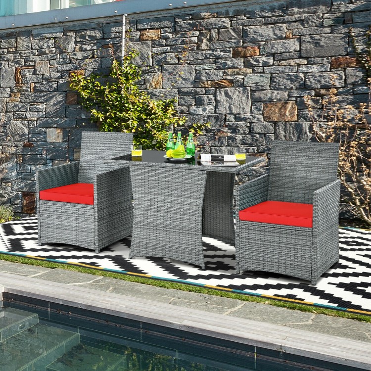 3 pieces patio rattan furniture set with cushioned armrests and red cushions, perfect for outdoor dining and relaxation.