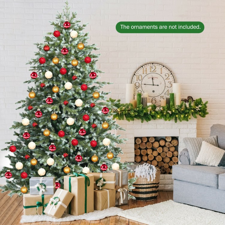 7 feet artificial Christmas tree with 1260 mixed PE and PVC tips, set up in a cozy living room with gifts underneath.