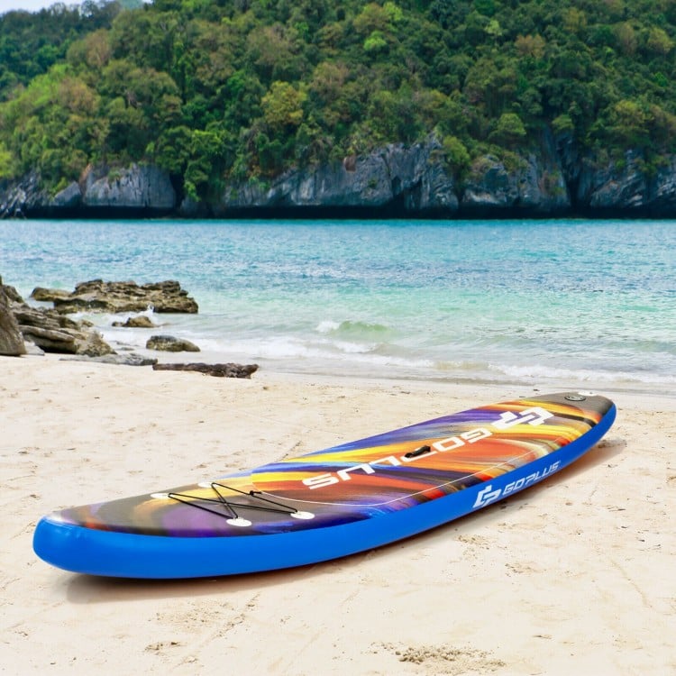 Inflatable stand-up paddle board in vibrant colors on the beach, ideal for water activities like surfing and yoga.