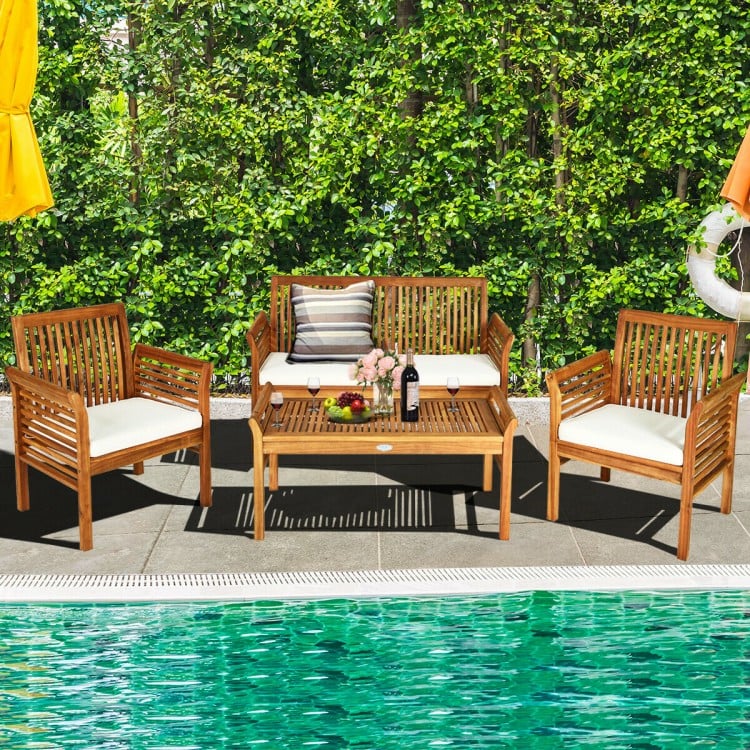 4-piece outdoor acacia wood sofa set with soft cushions, perfect for patio or poolside relaxation.