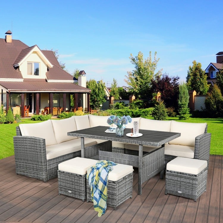 7-piece all-weather patio rattan dining set with off-white cushions, featuring a table, corner chairs, and ottomans for.
