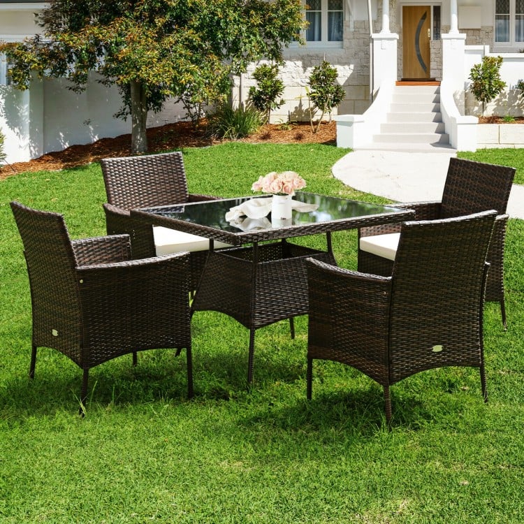 Outdoor 5-piece dining table set featuring a sturdy steel frame, PE rattan, and soft cushions for patio relaxation.