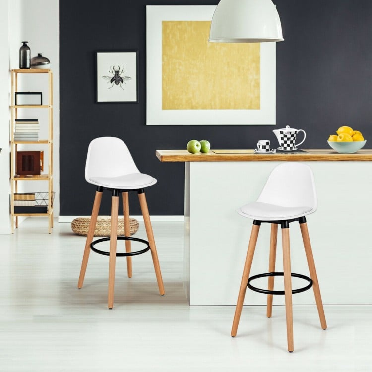 Mid-century barstools with white PU leather seats and beech wood legs, ideal for dining rooms or home bars.