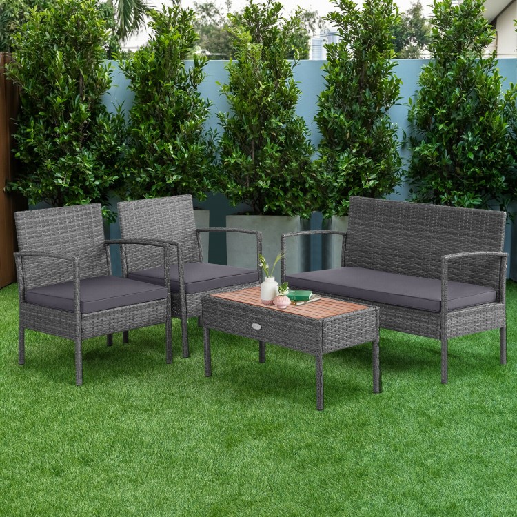 Rattan patio conversation set featuring 2 single sofas, a loveseat, and an acacia wood tabletop, perfect for outdoor.