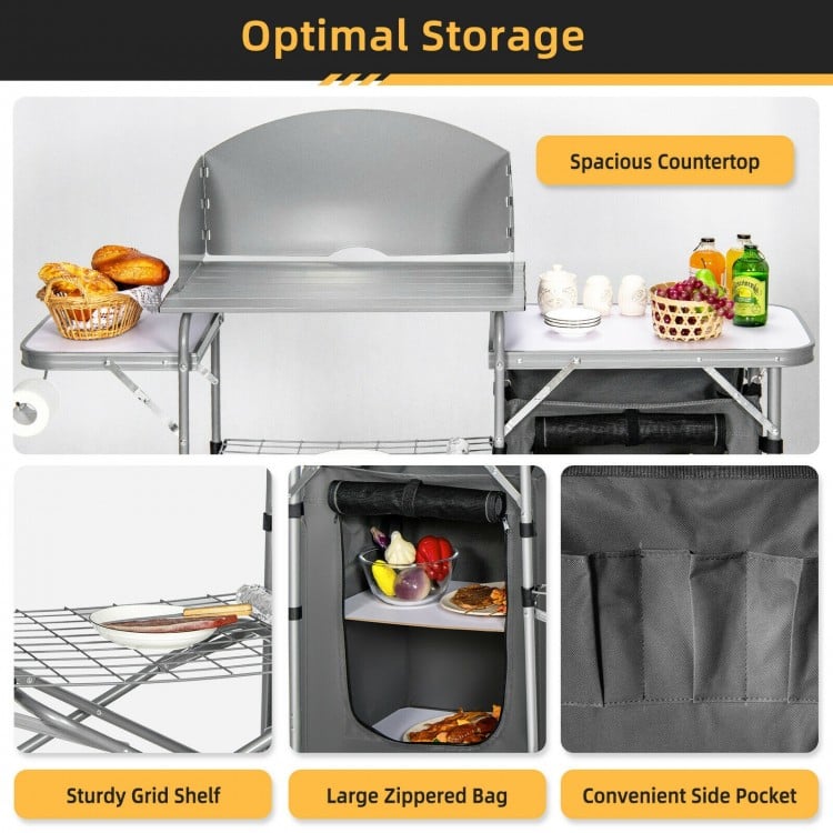 Foldable outdoor BBQ grilling table with windscreen, sturdy aluminum frame, spacious countertop, perfect for camping.