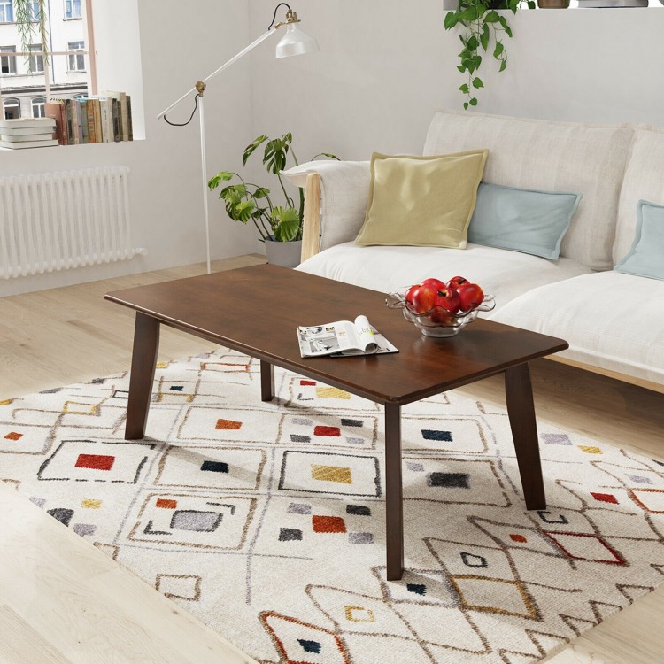 Rectangular modern wooden coffee table with rubber legs, showcasing a spacious tabletop and round edges for added.