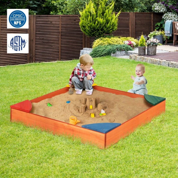 Kids playing in a colorful wooden sandbox with built-in corner seating, made from durable cedar and pine wood.