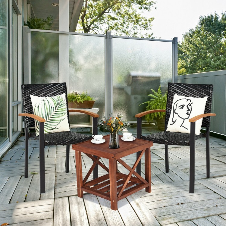 Two outdoor patio wicker dining chairs with ergonomic armrests and a rustic acacia wood table for stylish relaxation.