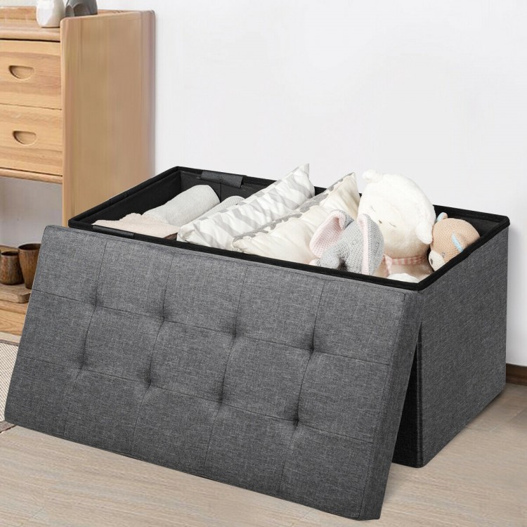 Foldable dark gray storage ottoman with removable bin, featuring a padded seat and spacious interior for blankets and.