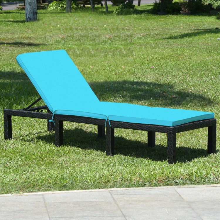Height adjustable rattan lounge chair with blue cushion, perfect for patio or poolside relaxation.