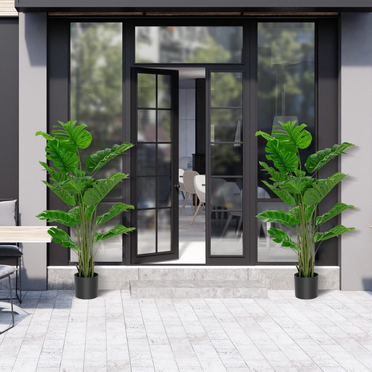 Two 5-foot artificial monstera trees in cement pots, featuring 15 large leaves each, ideal for indoor or outdoor.