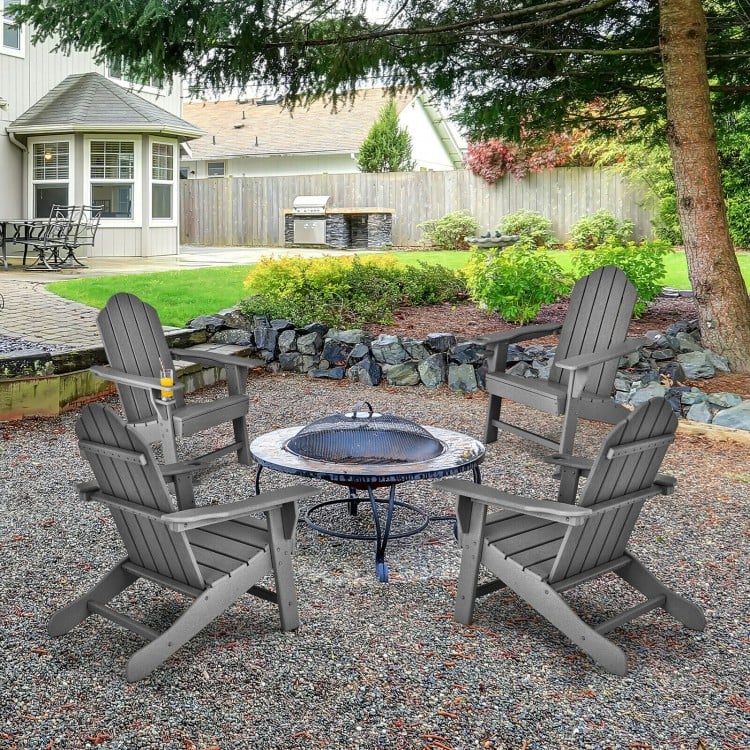 Gray outdoor Adirondack chairs with built-in cup holders arranged around a fire pit, ideal for backyard gatherings.