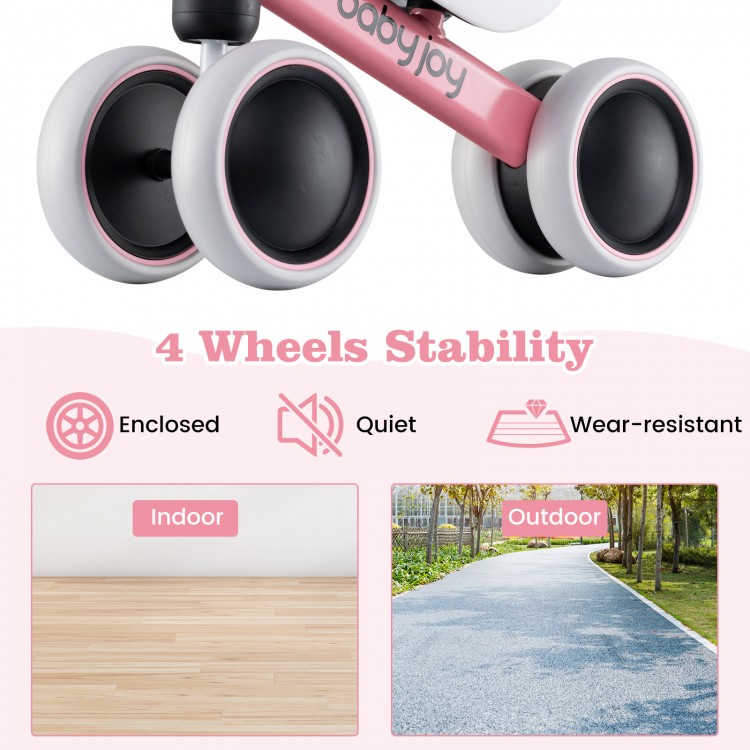 Baby balance bike in pink with 4 enclosed wheels, suitable for indoor and outdoor use, promoting stability and safety.