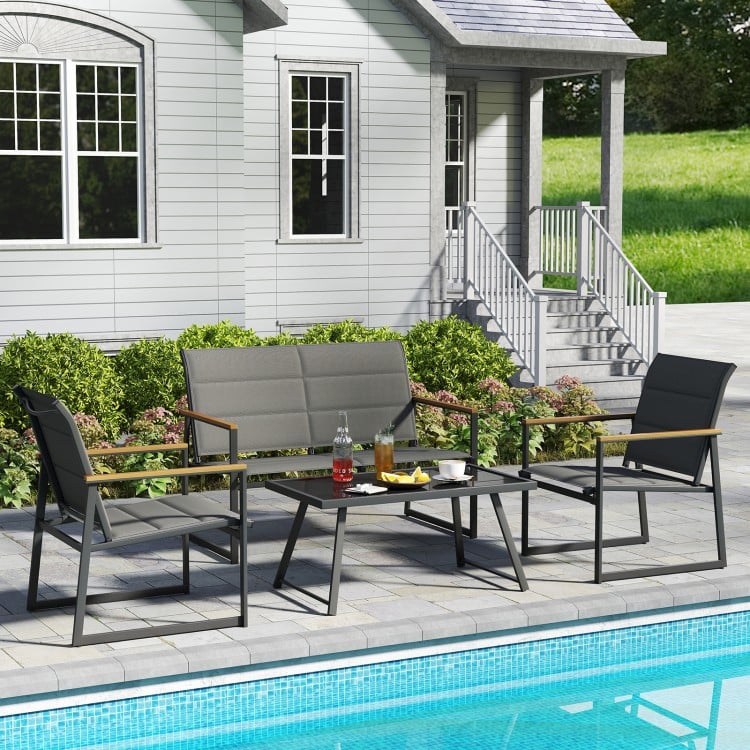 4-piece outdoor conversation patio furniture set in gray, featuring a loveseat, two armchairs, and a coffee table by.