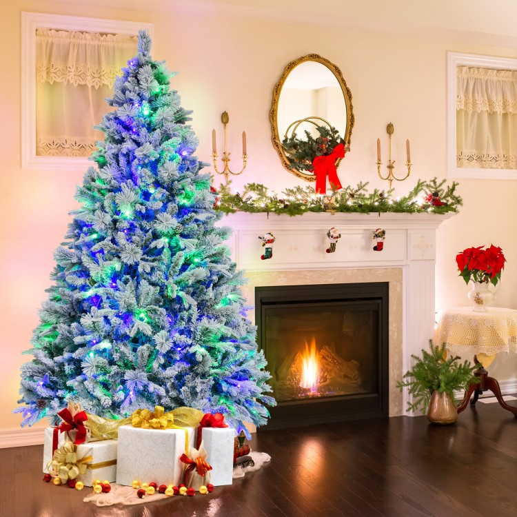 7 ft artificial Christmas tree with white flocking, LED lights, and pine cones, perfect for festive home decoration.