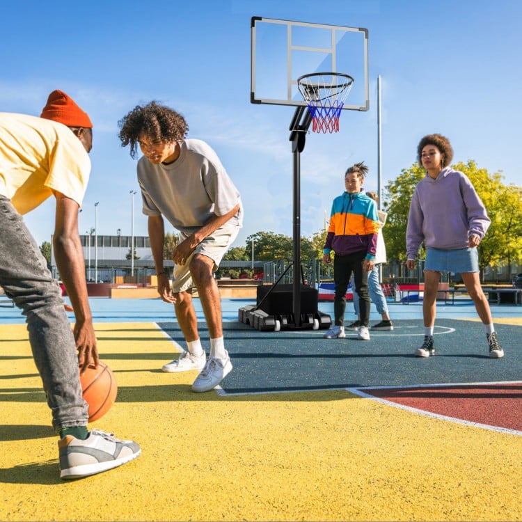 Adjustable basketball hoop with shatterproof backboard, shown in use on a colorful outdoor court for all ages.
