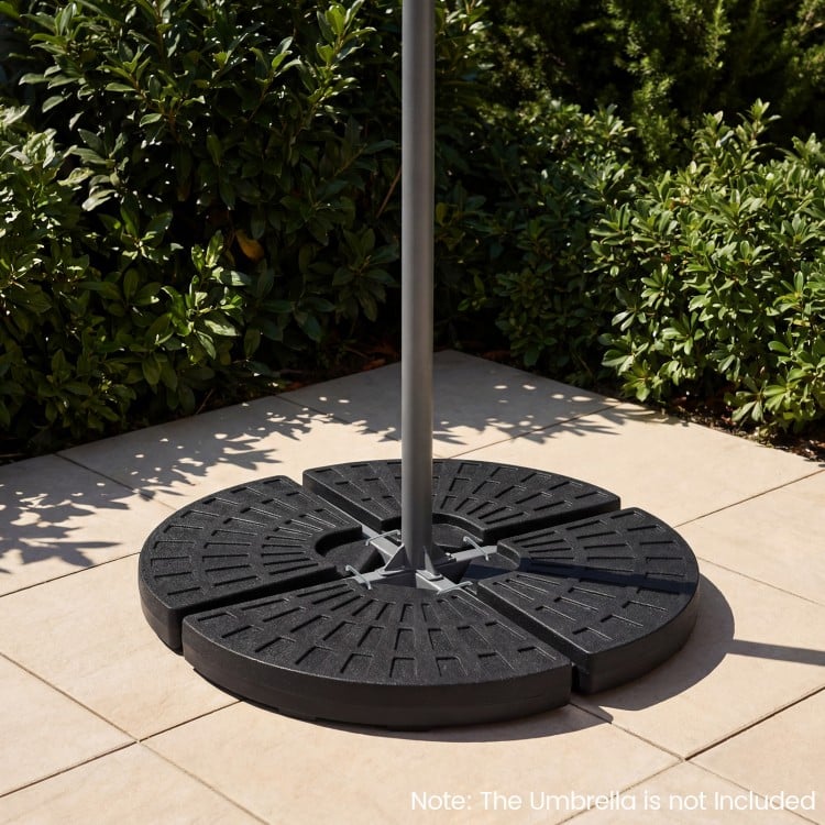 Heavy-duty 4-piece patio umbrella base in black, designed for stability with interlocking plates and U-locking pins.