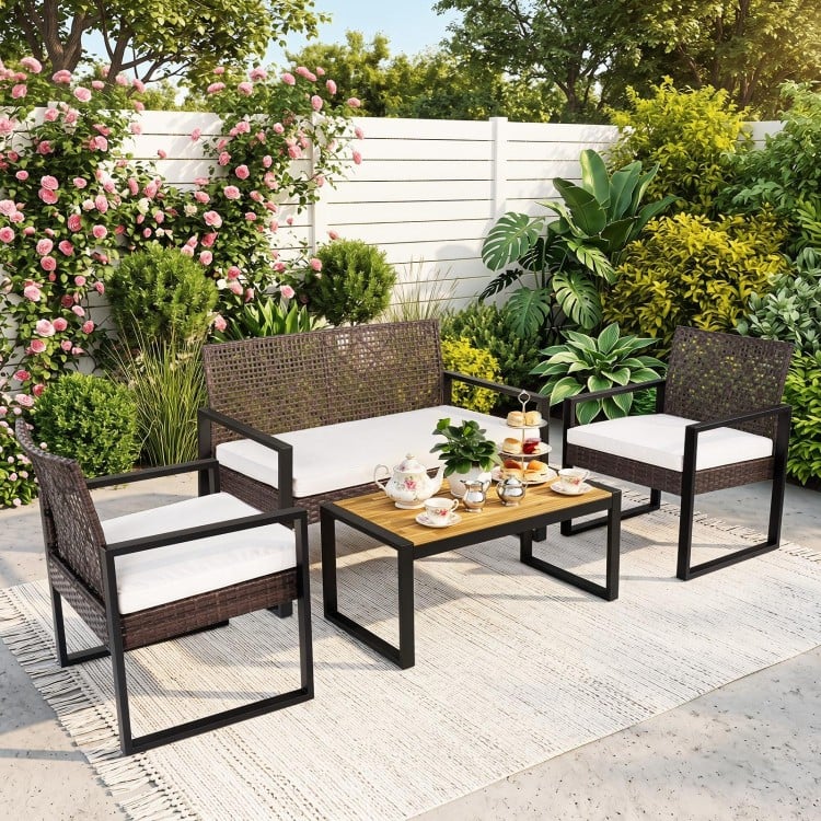 4-piece patio set featuring brown wicker chairs and an acacia coffee table, perfect for backyard relaxation.