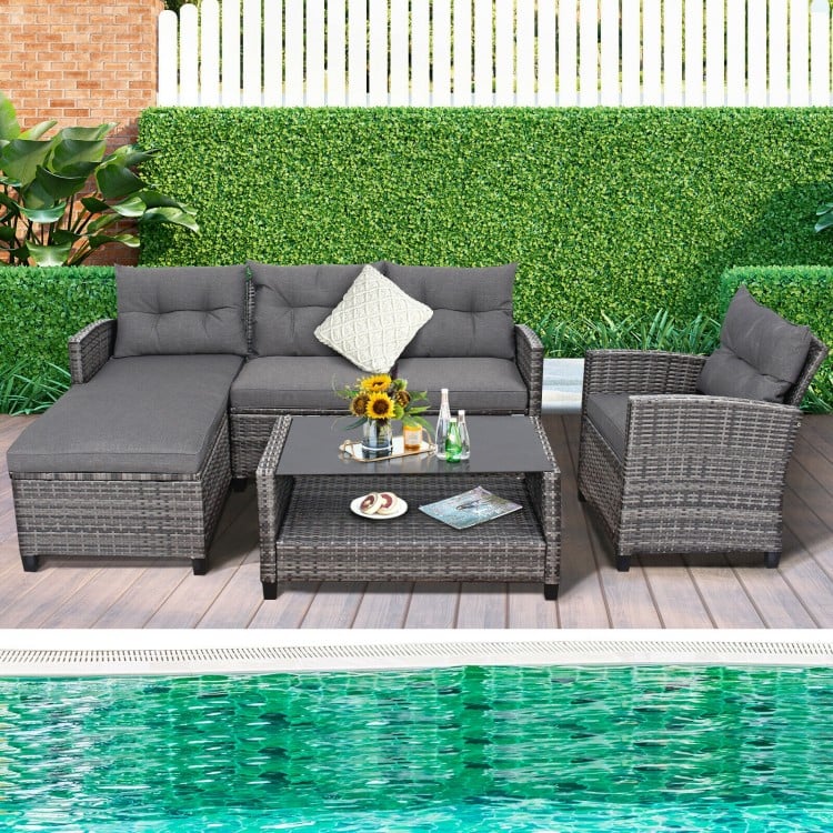 4-piece gray patio rattan furniture set with cushions and glass-top table, perfect for poolside or backyard relaxation.