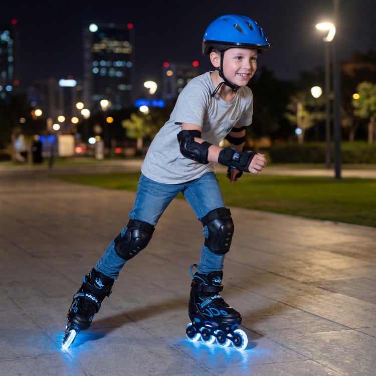 Youth roller skates in blue with light-up wheels, adjustable sizes, and protective gear for safe skating at night.